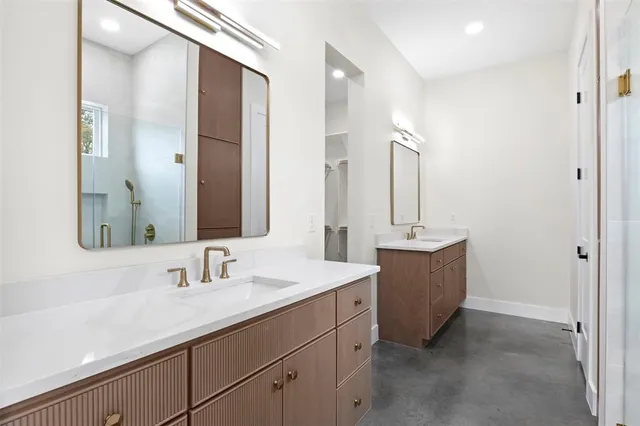 a bathroom with a sink double vanity and a mirror