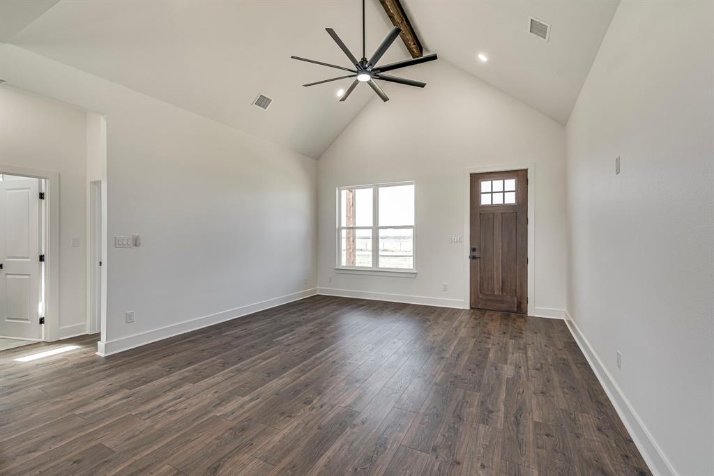 210 Wester Road Ferris, TX 75125 - Photo 21 of 25 an empty room with wooden floor fan and windows