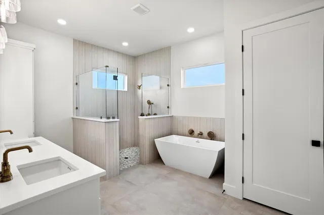 a bathroom with a tub sink and mirror