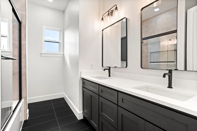 a bathroom with a double vanity sink and mirror