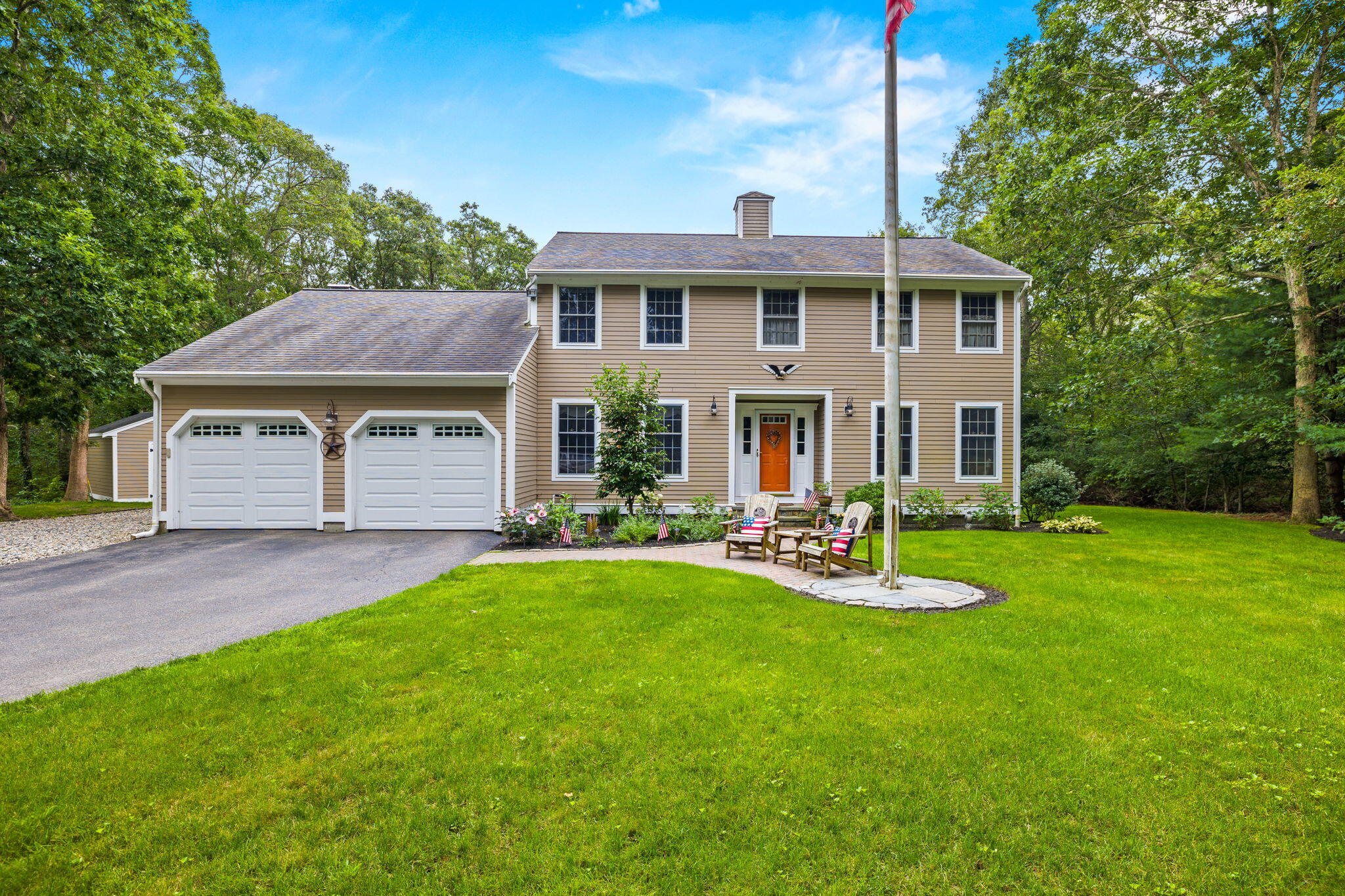 a front view of a house with swimming pool having outdoor seating