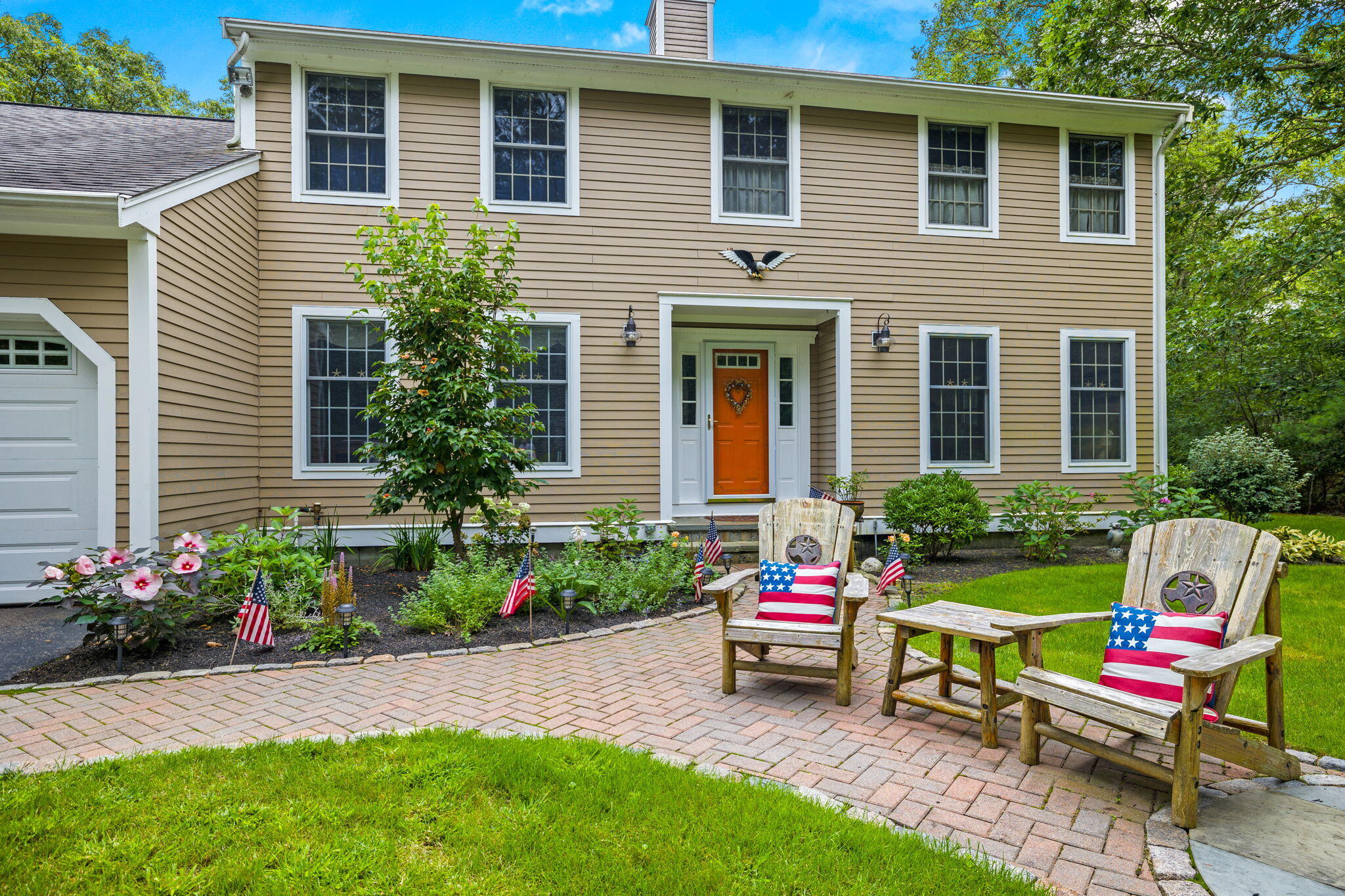 72 John Ewer Road Sandwich, MA 02563 - Photo 3 of 38 a front view of a house with a yard and sitting area