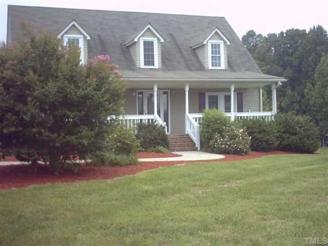 981 Robertson Road Roxboro, NC 27574 - Photo 2 of 7 a front view of a house with a yard and trees