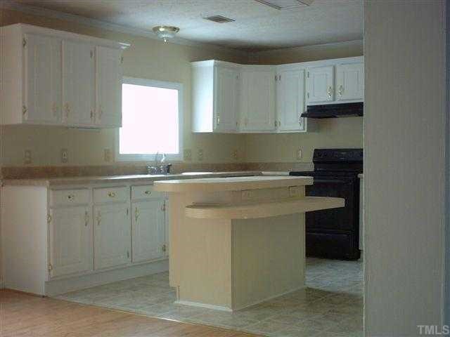 981 Robertson Road Roxboro, NC 27574 - Photo 3 of 7 a kitchen with white cabinets and sink