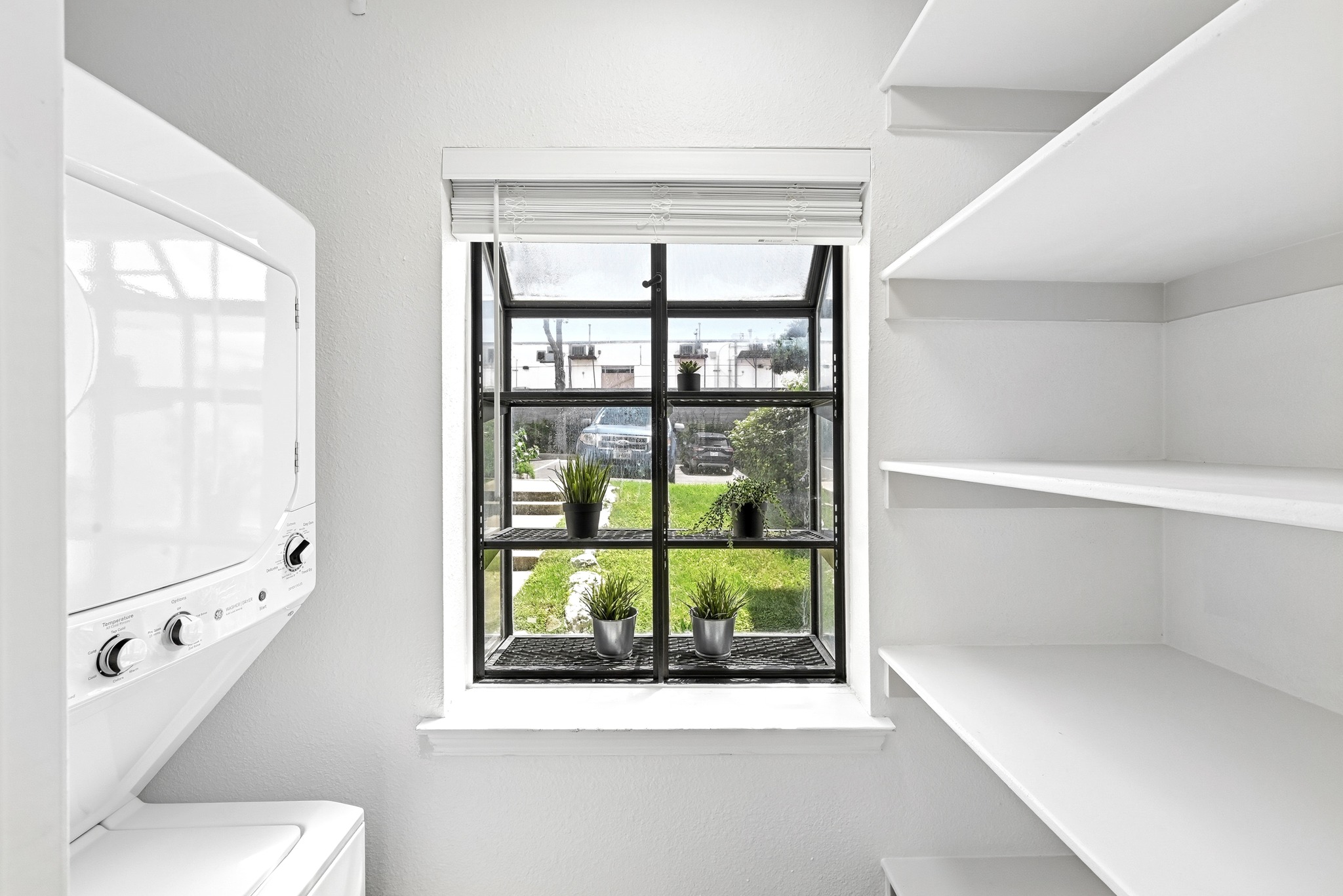 2215 Post Road, Unit 1026 Austin, TX 78704 - Photo 12 of 29 2025 WD that conveys. Pantry shelving to the right. Bay window that gets great natural light for your herbs!