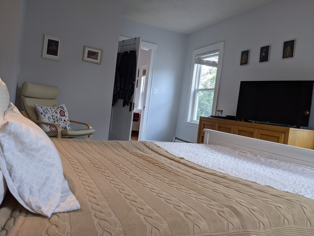 184 White Street, Unit 2 Belmont, MA 02478 - Photo 15 of 29 a bedroom with a bed and a flat screen tv