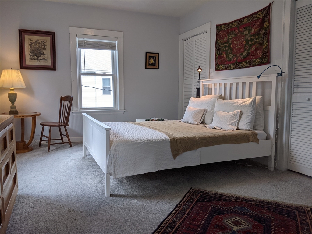 184 White Street, Unit 2 Belmont, MA 02478 - Photo 18 of 29 a bedroom with a bed and chair