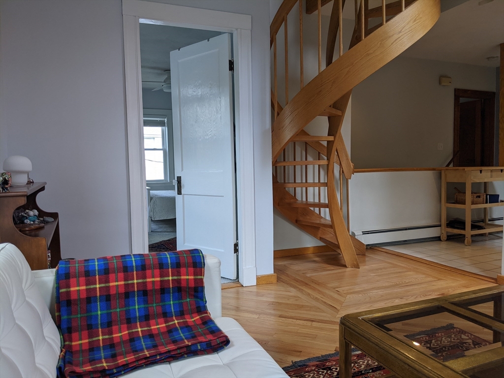 184 White Street, Unit 2 Belmont, MA 02478 - Photo 25 of 29 a bedroom with a bed and wooden floor