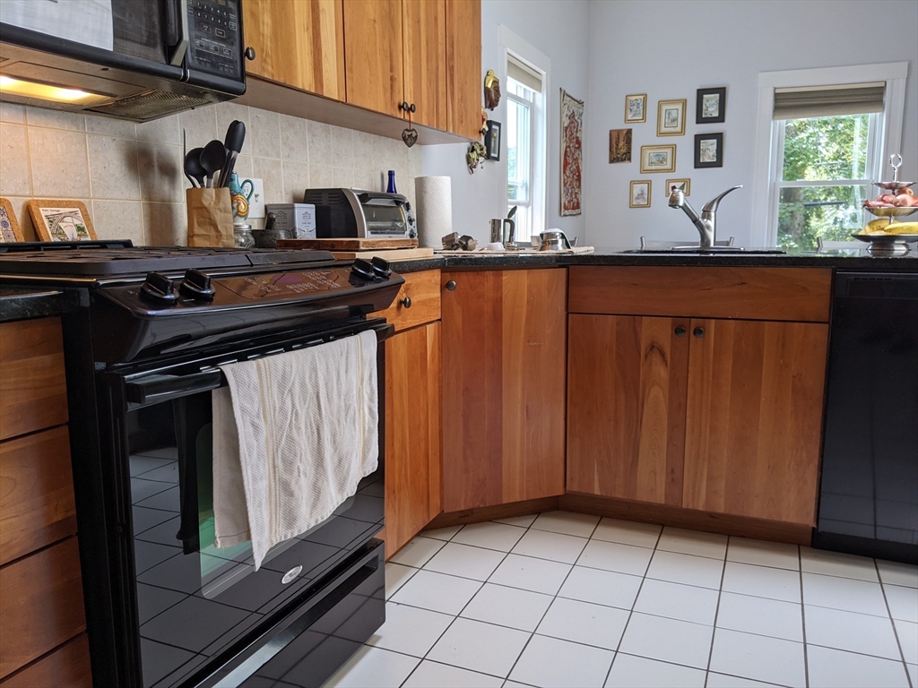 184 White Street, Unit 2 Belmont, MA 02478 - Photo 28 of 29 a kitchen with granite countertop a stove a sink and dishwasher