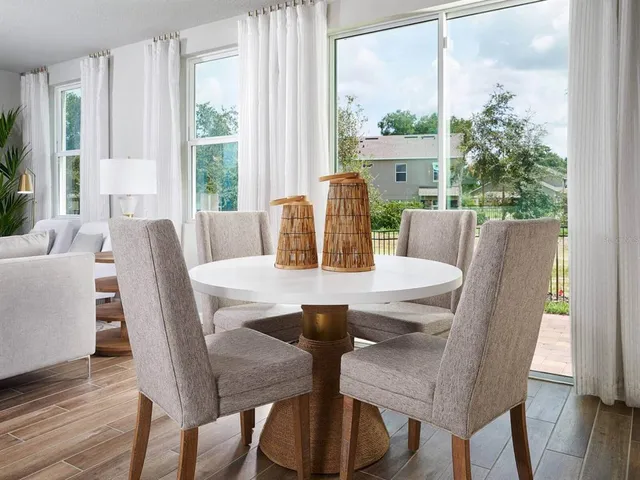 a view of a dining room with furniture window and wooden floor