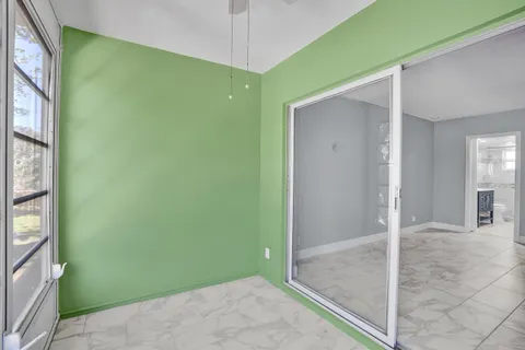 an empty room with windows and closet