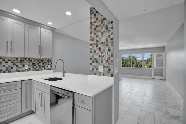 a kitchen that has a sink and a stove in it