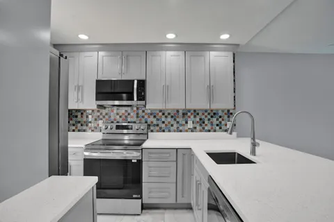 a kitchen with a sink stove and microwave