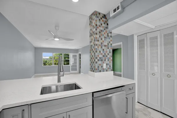 a view of bathroom with a sink and chandelier