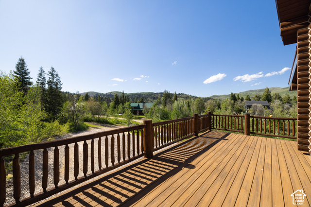 917 West Deep Forest Road Coalville, UT 84017 - Photo 31 of 41 Expansive wooden deck with turned balusters, featuring a wood plank surface and a log-style exterior wall