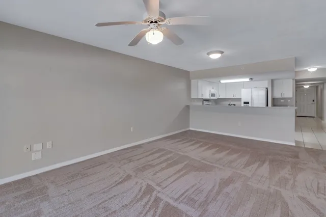 a view of a kitchen with a sink and a refrigerator
