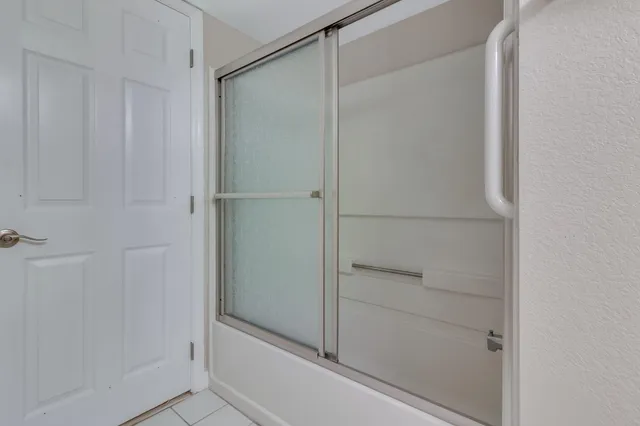 a bathroom with a glass shower door