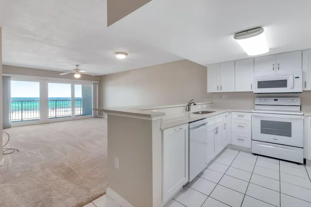a kitchen with a stove sink and cabinets