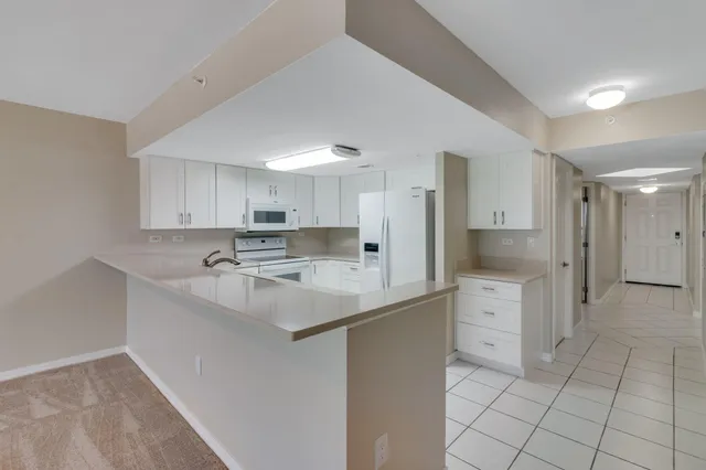 a kitchen with a sink window and cabinets