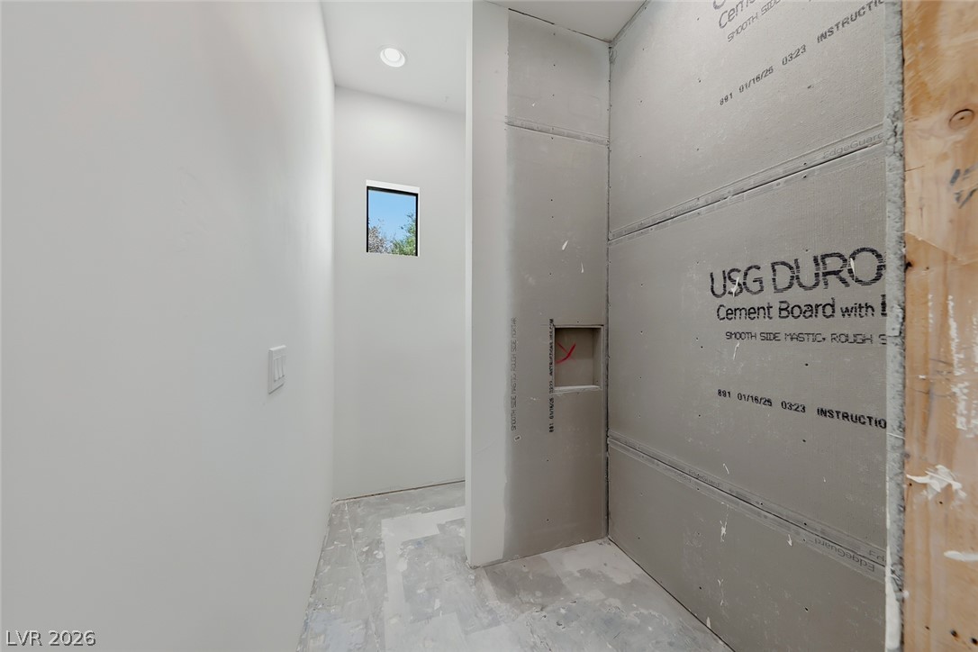 1140 Julie Road Henderson, NV 89002 - Photo 57 of 71 A well-lit, partially constructed bathroom awaits finishing touches, promising modern design.
