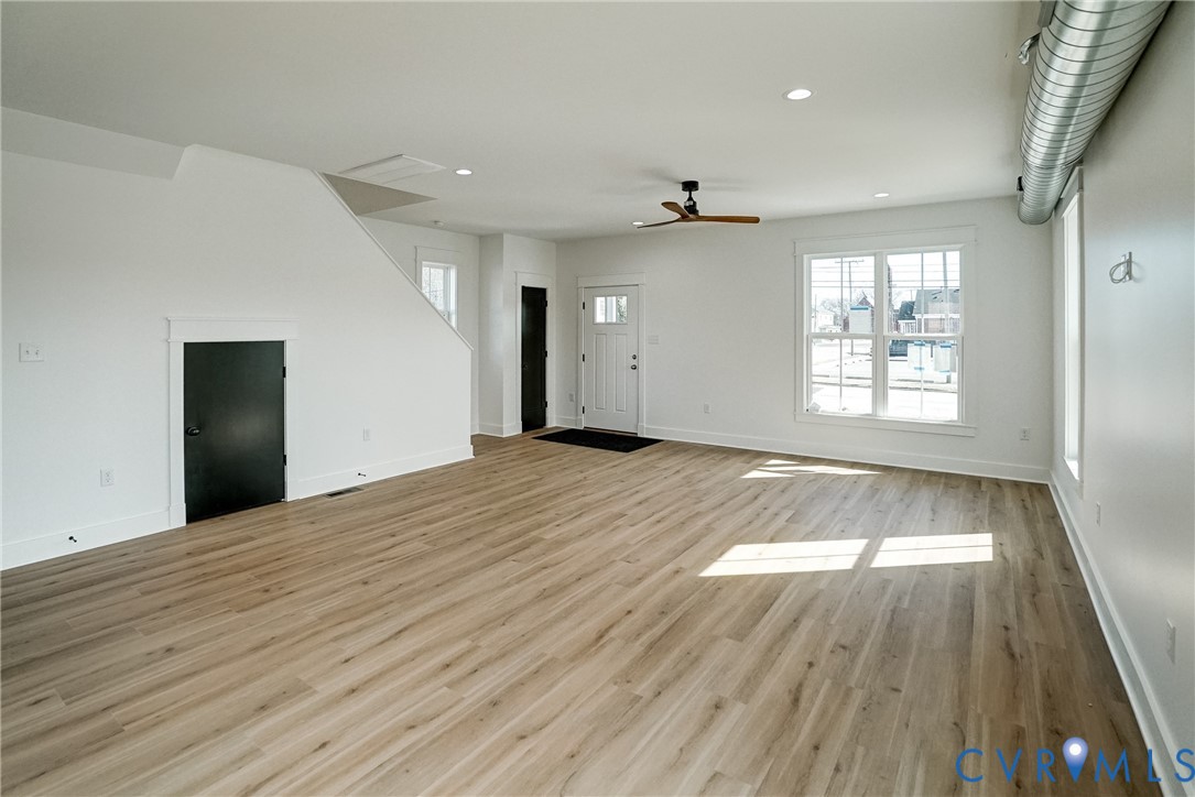 901 Commerce Street Petersburg, VA 23803 - Photo 12 of 40 an empty room with wooden floor and windows