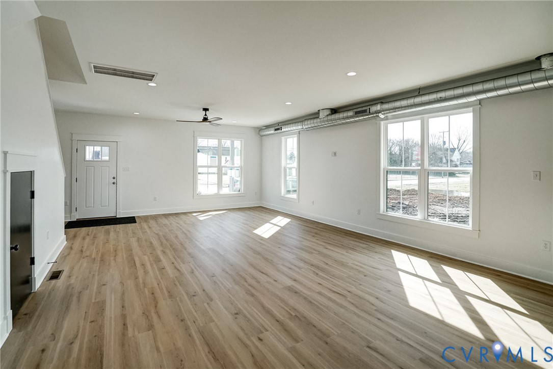 901 Commerce Street Petersburg, VA 23803 - Photo 13 of 40 a view of empty room with wooden floor and fan