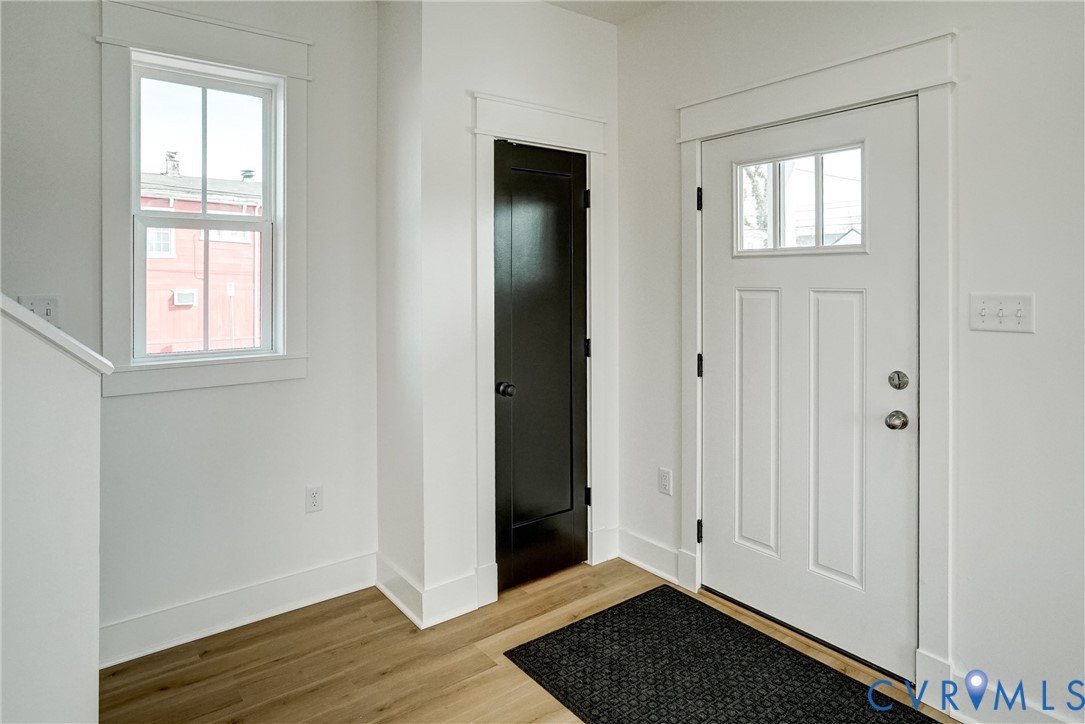 901 Commerce Street Petersburg, VA 23803 - Photo 14 of 40 an empty room with wooden floor closet and windows