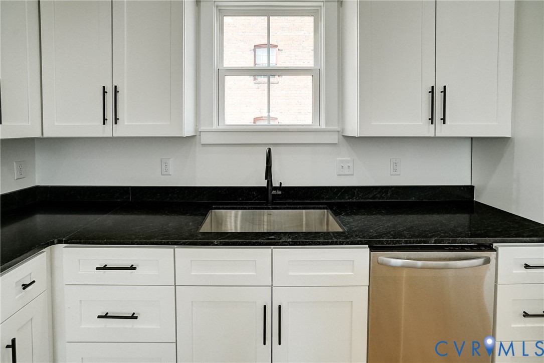 901 Commerce Street Petersburg, VA 23803 - Photo 22 of 40 a kitchen with white cabinets and window