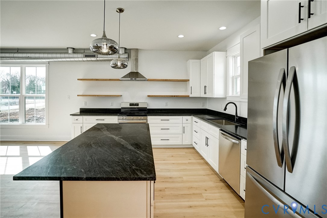 901 Commerce Street Petersburg, VA 23803 - Photo 24 of 40 a large kitchen with stainless steel appliances granite countertop a sink a stove and a refrigerator
