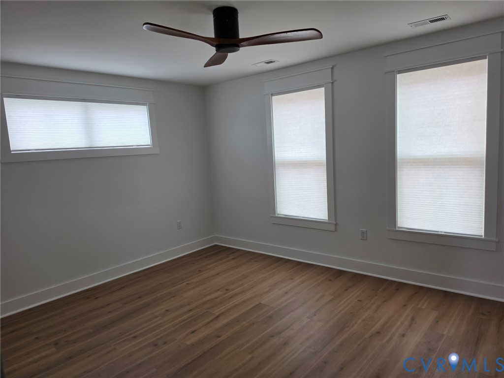 901 Commerce Street Petersburg, VA 23803 - Photo 26 of 40 a view of an empty room with wooden floor and a window