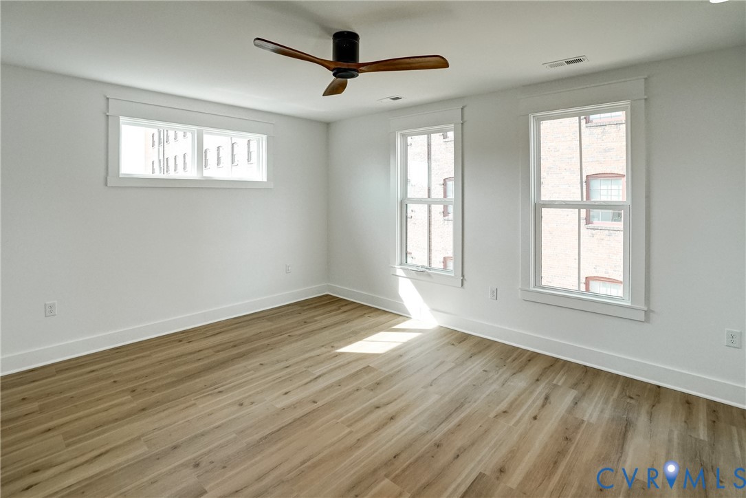 901 Commerce Street Petersburg, VA 23803 - Photo 27 of 40 a view of an empty room with wooden floor and a window