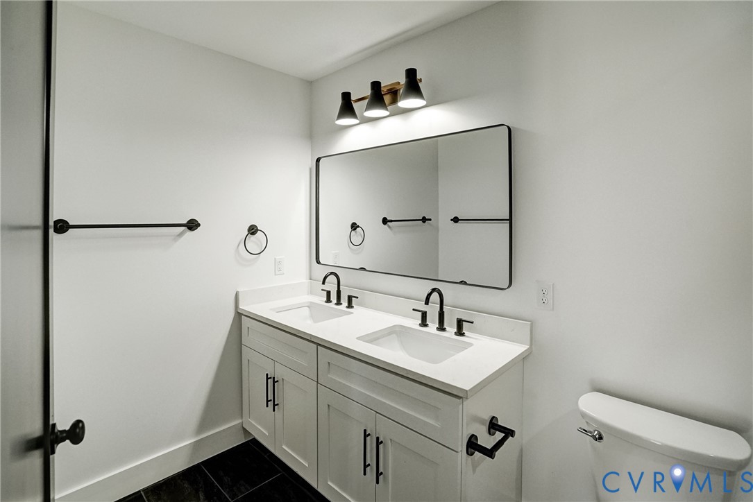 901 Commerce Street Petersburg, VA 23803 - Photo 31 of 40 a bathroom with a sink mirror vanity and toilet