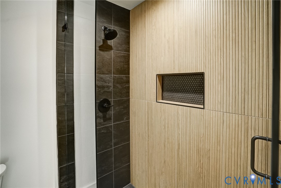 901 Commerce Street Petersburg, VA 23803 - Photo 33 of 40 a bathroom with a shower and a mirror