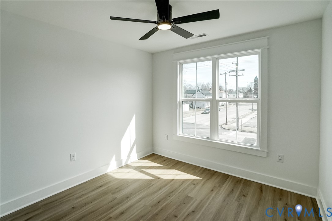 901 Commerce Street Petersburg, VA 23803 - Photo 36 of 40 a view of empty room with wooden floor and fan