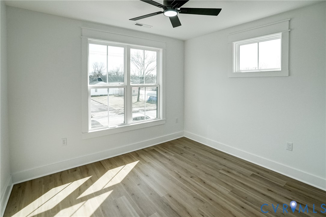 901 Commerce Street Petersburg, VA 23803 - Photo 38 of 40 a view of an empty room with wooden floor and a window