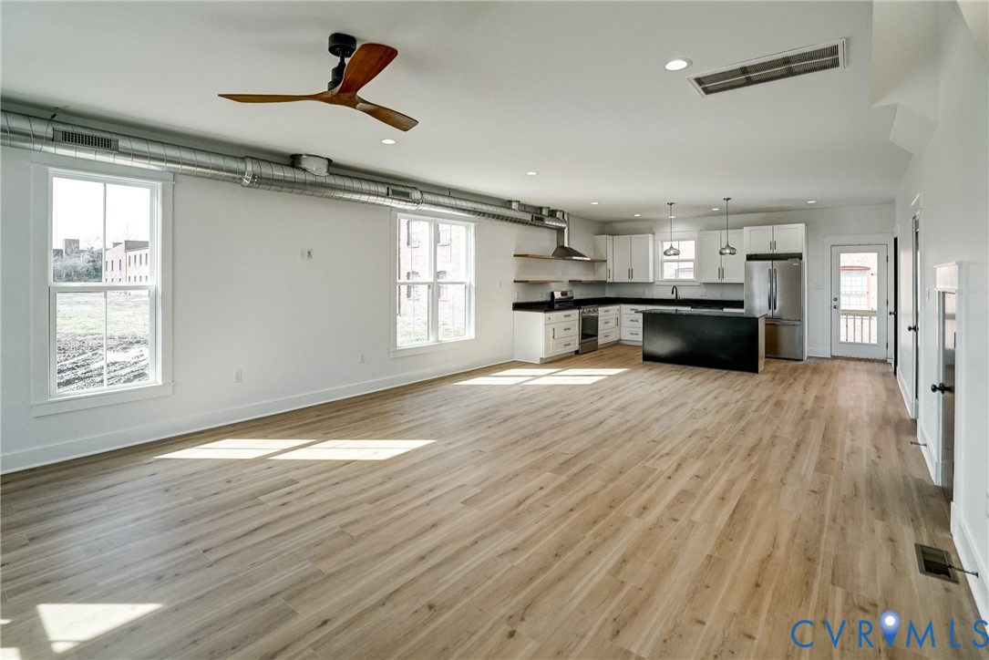 901 Commerce Street Petersburg, VA 23803 - Photo 8 of 40 a view of empty room with wooden floor and fan