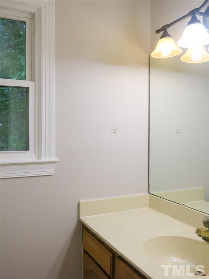 6820 Gloucester Road Raleigh, NC 27612 - Photo 16 of 25 a bathroom with a sink and vanity