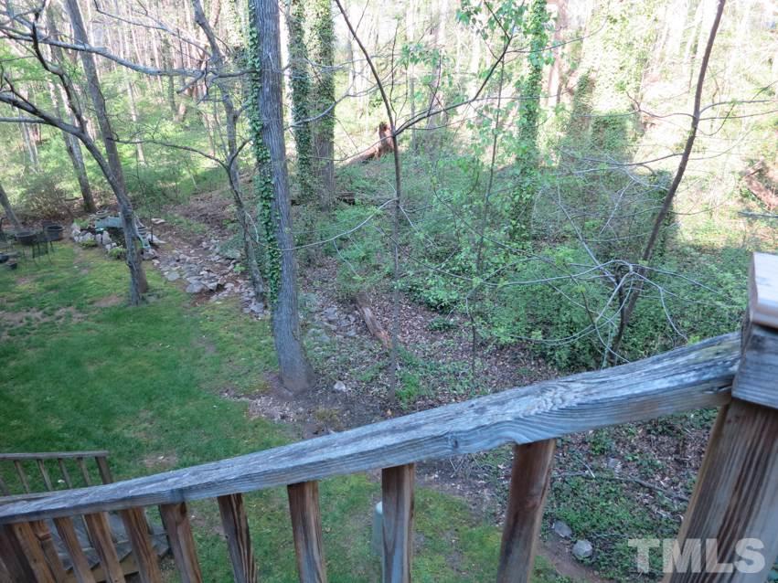 6820 Gloucester Road Raleigh, NC 27612 - Photo 23 of 25 a view of a wooden deck and forest