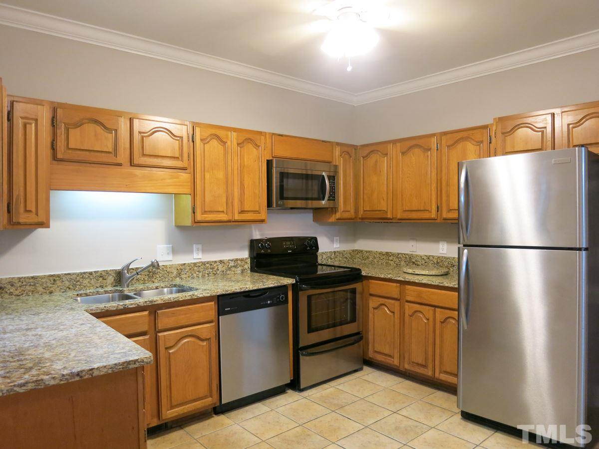 6820 Gloucester Road Raleigh, NC 27612 - Photo 8 of 25 a kitchen with stainless steel appliances granite countertop a refrigerator stove microwave and sink