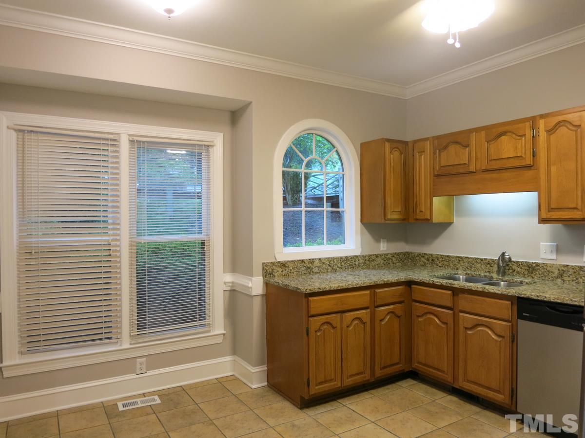 6820 Gloucester Road Raleigh, NC 27612 - Photo 9 of 25 a kitchen with a sink window and cabinets