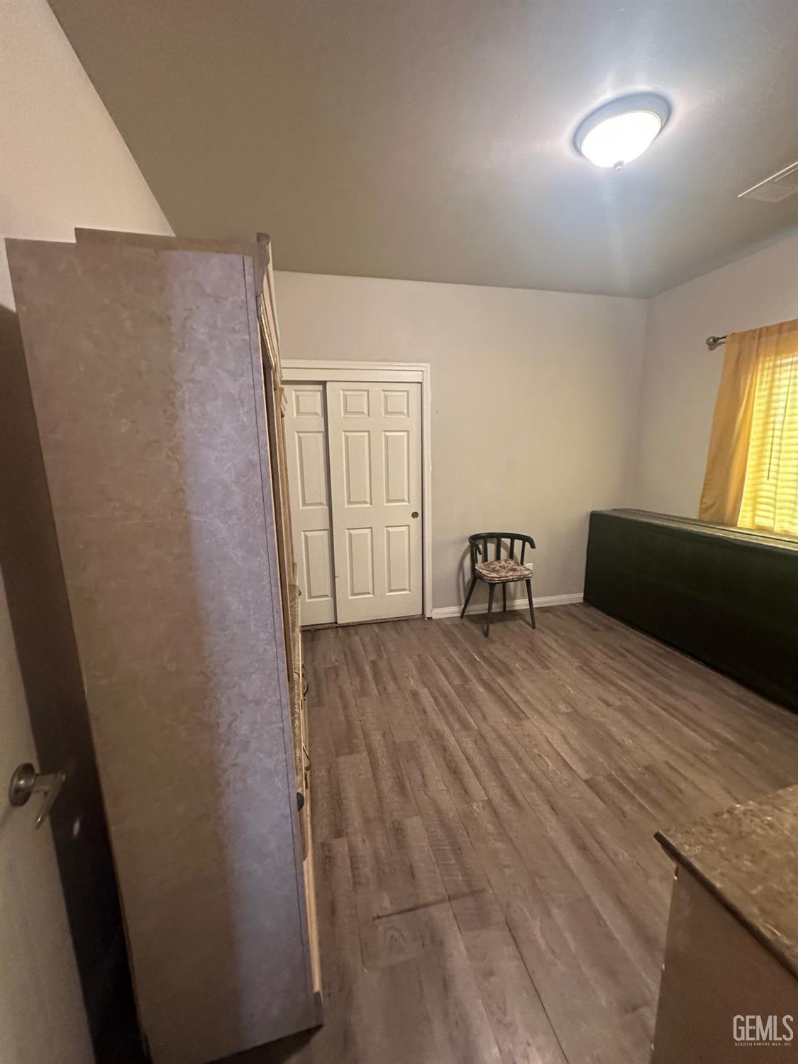 Undisclosed Address Wasco, CA 93280 - Photo 13 of 24 a bedroom with a bed and window