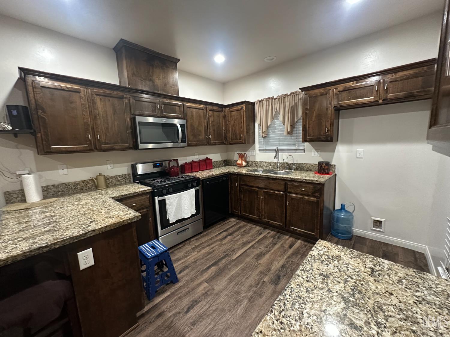 Undisclosed Address Wasco, CA 93280 - Photo 7 of 24 a kitchen with stainless steel appliances granite countertop a sink stove and refrigerator