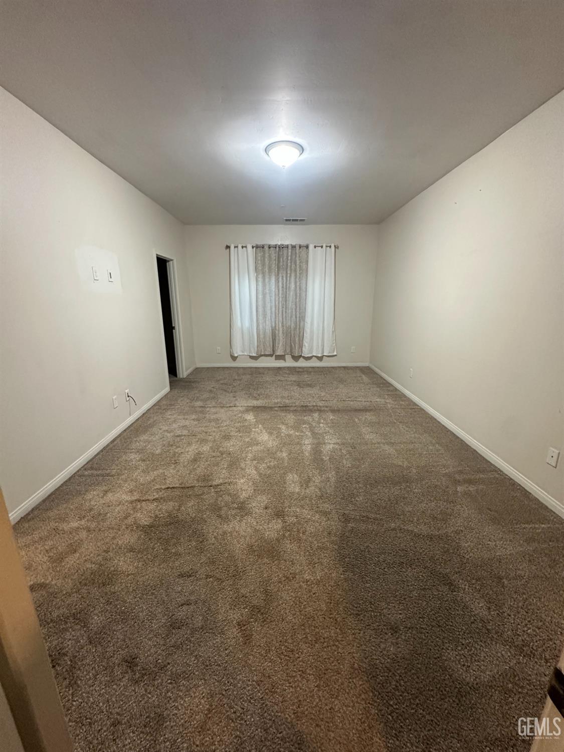 Undisclosed Address Wasco, CA 93280 - Photo 8 of 24 an empty room with windows