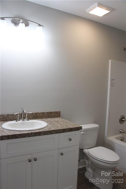 4256 Fletcher Funderburk Road Lancaster, SC 29720 - Photo 14 of 18 a bathroom with a granite countertop sink and a toilet
