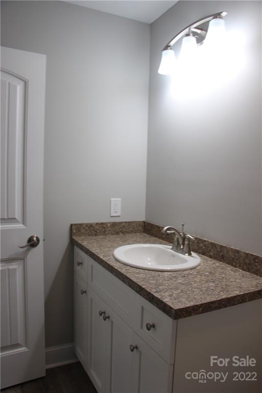 4256 Fletcher Funderburk Road Lancaster, SC 29720 - Photo 16 of 18 a bathroom with a granite countertop sink and a mirror
