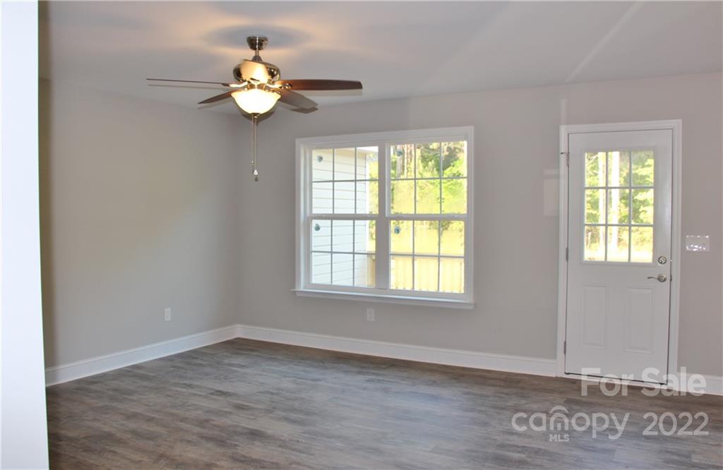 4256 Fletcher Funderburk Road Lancaster, SC 29720 - Photo 3 of 18 an empty room with wooden floor and windows