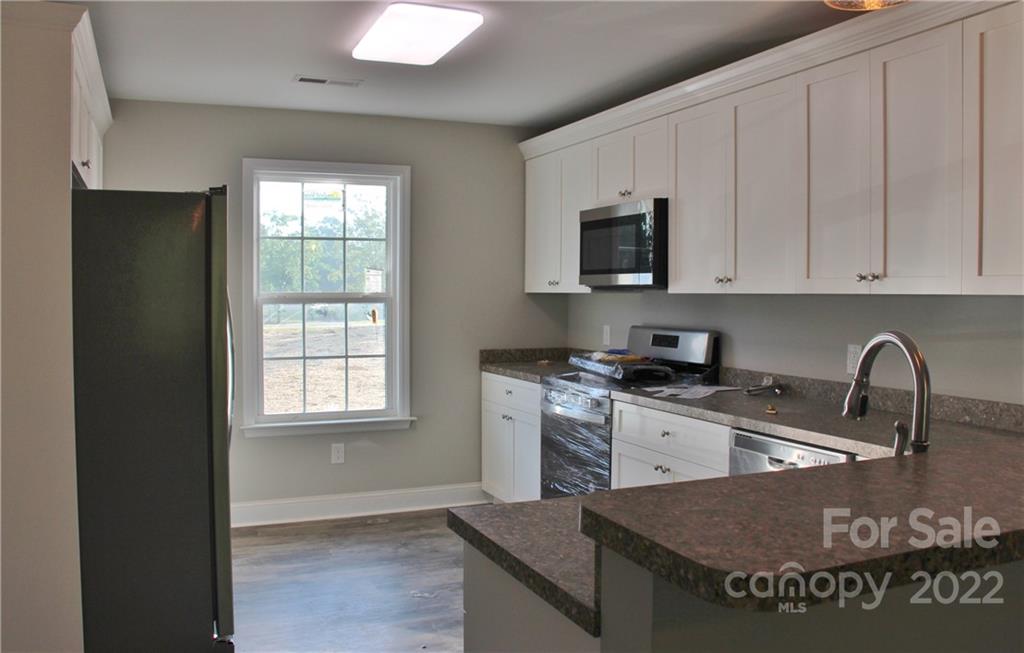 4256 Fletcher Funderburk Road Lancaster, SC 29720 - Photo 6 of 18 a kitchen with granite countertop a stove a sink and a granite counter tops