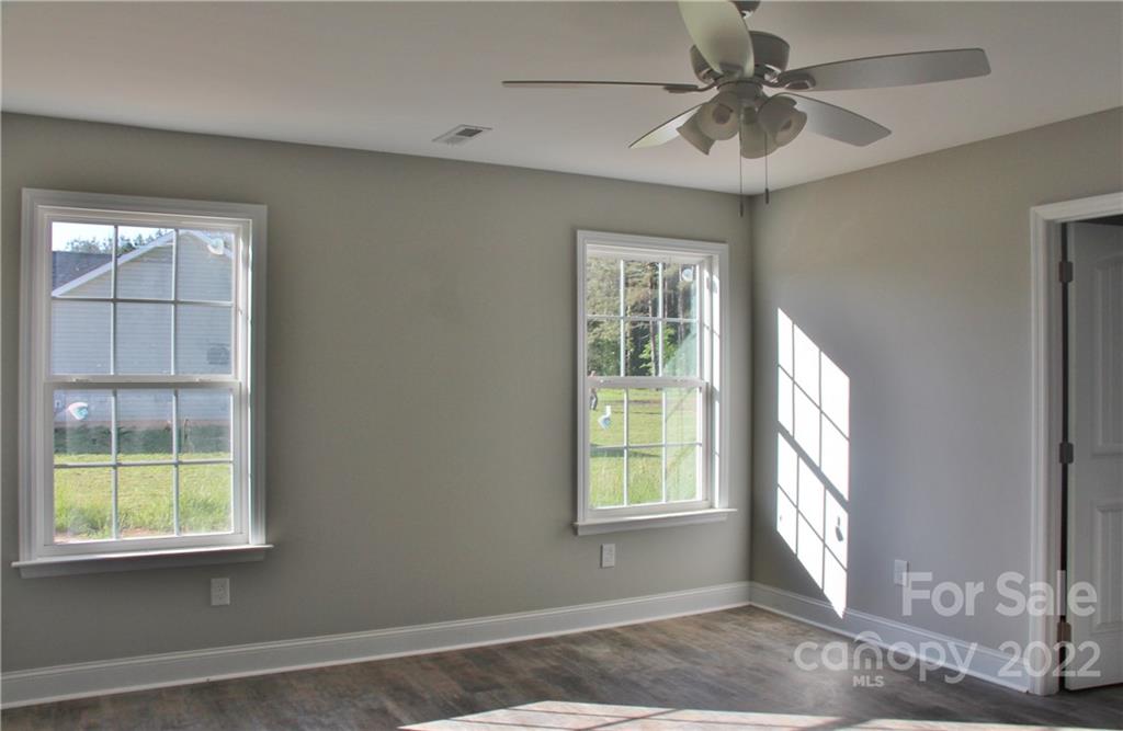 4256 Fletcher Funderburk Road Lancaster, SC 29720 - Photo 9 of 18 an empty room with windows and fan