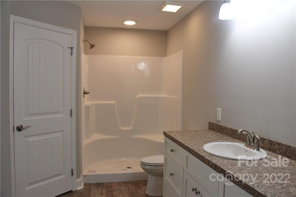 4256 Fletcher Funderburk Road Lancaster, SC 29720 - Photo 10 of 18 a bathroom with a granite countertop sink toilet and shower