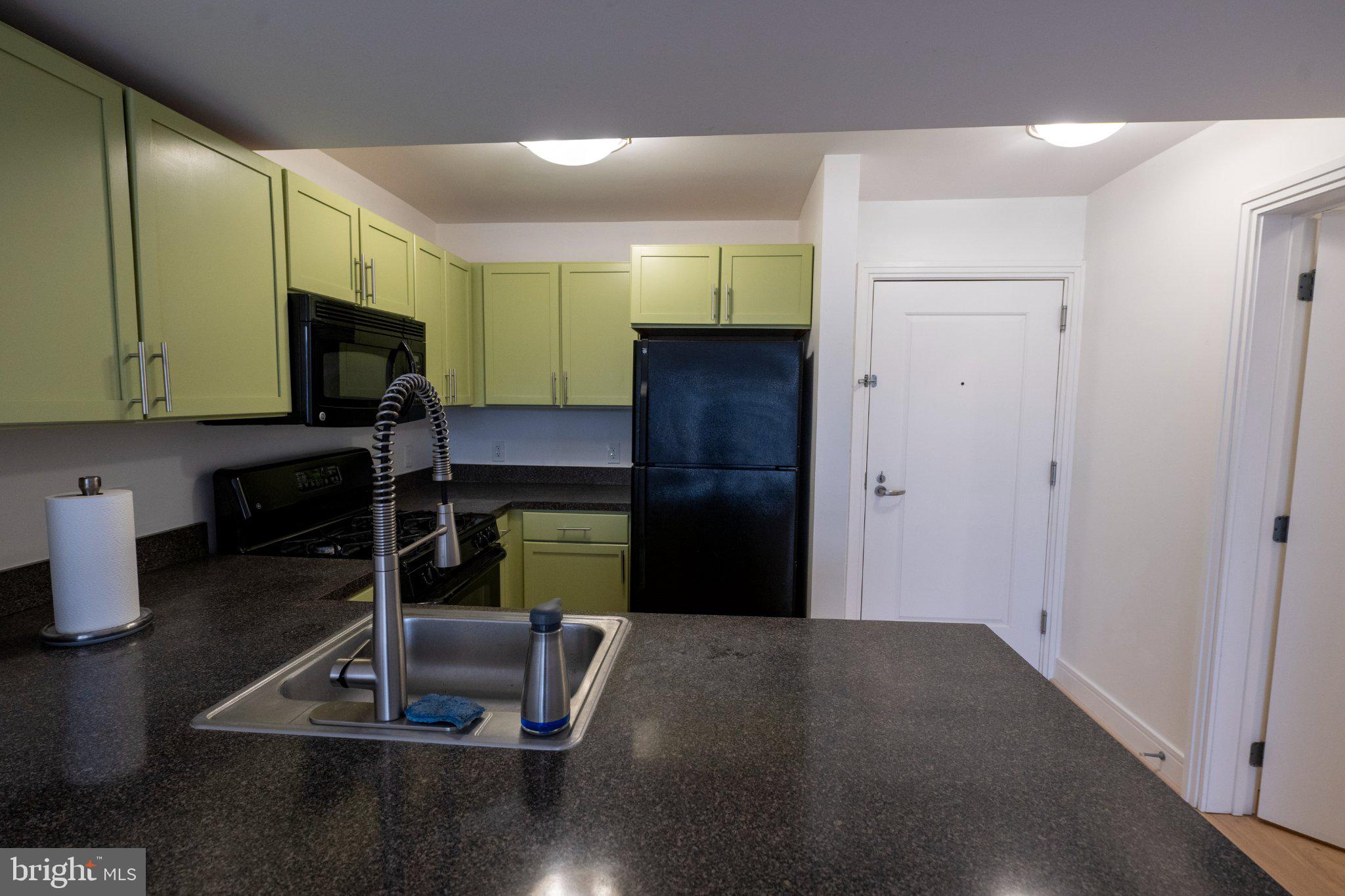 800 4th Street Southwest, Unit N107 Washington, DC 20024 - Photo 16 of 52 Modern kitchen with vibrant cabinetry.